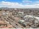 Neighborhood aerial view showing the street with parked cars and the city skyline on the horizon at 4440 W Hayward Pl, Denver, CO 80212