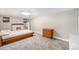 Cozy basement bedroom with carpet flooring, painted fireplace, and neutral walls at 4440 W Hayward Pl, Denver, CO 80212