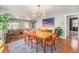 Elegant dining room featuring a modern light fixture and seamlessly connected living spaces at 4440 W Hayward Pl, Denver, CO 80212