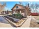 Inviting exterior view showcasing the brickwork, well-kept landscaping, and sidewalk access at 4440 W Hayward Pl, Denver, CO 80212