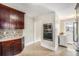 Functional kitchen featuring built-in microwave and oven, dark wood cabinetry, and tile flooring at 4440 W Hayward Pl, Denver, CO 80212