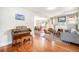 Open-concept living space with hardwood floors, a fireplace, and views of the dining area at 4440 W Hayward Pl, Denver, CO 80212