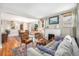 Spacious living room featuring a fireplace, hardwood floors, and plenty of natural light at 4440 W Hayward Pl, Denver, CO 80212