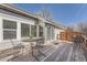 Wooden back deck with weathered finish and iron patio furniture near sliding glass doors for indoor-outdoor living at 2275 S Kenton St, Aurora, CO 80014