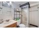 Bathroom featuring a tiled shower, modern vanity, and a framed mirror in a well-lit space at 2275 S Kenton St, Aurora, CO 80014