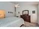 Bright bedroom featuring soft carpet, wood furniture, and an ensuite bathroom at 2275 S Kenton St, Aurora, CO 80014
