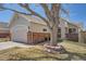 Charming home exterior featuring a well-maintained lawn and mature tree with brick accents around the house at 2275 S Kenton St, Aurora, CO 80014