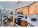 Bright kitchen featuring stainless steel appliances, wooden cabinets, and a cozy breakfast nook at 2275 S Kenton St, Aurora, CO 80014