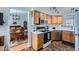 Well-lit kitchen showcasing modern appliances and oak cabinets, with a partial view into the adjacent dining area at 2275 S Kenton St, Aurora, CO 80014