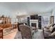 Inviting living room with a cozy fireplace, large windows, hardwood floors, and plush seating arrangement at 2275 S Kenton St, Aurora, CO 80014