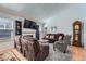 Bright living room with a fireplace, vaulted ceilings, plush seating, and an ornate grandfather clock by the wall at 2275 S Kenton St, Aurora, CO 80014