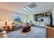 Finished basement living room with cozy seating, neutral carpet, and a half wall to an adjoining room at 2275 S Kenton St, Aurora, CO 80014