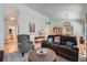 Spacious living room featuring vaulted ceilings, hardwood floors, a comfortable sofa, and an elegant round coffee table at 2275 S Kenton St, Aurora, CO 80014