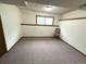 Basement area with neutral carpeting, window, and chair, providing a cozy and functional space at 3262 S Salida Way, Aurora, CO 80013