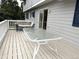 Outdoor deck with a glass-top table and cushioned swing, ideal for relaxation and entertaining at 3262 S Salida Way, Aurora, CO 80013