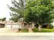 Charming brick home with mature trees and a well-manicured lawn at 3262 S Salida Way, Aurora, CO 80013