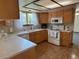 Well-lit kitchen with wood cabinets, white appliances, and view from window above sink at 3262 S Salida Way, Aurora, CO 80013