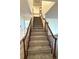 Carpeted stairway with wood railing leads to the upper level of the home at 3262 S Salida Way, Aurora, CO 80013
