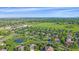 Aerial view of a residential neighborhood with green fields and a pond at 5746 Aspen Creek Dr, Broomfield, CO 80020
