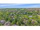 Aerial view of a neighborhood with mature trees and a small pond at 5746 Aspen Creek Dr, Broomfield, CO 80020