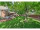 Lush backyard with mature trees, a patio, a gazebo, and a trampoline at 5746 Aspen Creek Dr, Broomfield, CO 80020