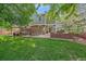 Spacious backyard with a patio, gazebo, fire pit, and lush green lawn at 5746 Aspen Creek Dr, Broomfield, CO 80020