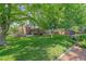 Expansive backyard featuring a patio, gazebo, mature trees, and a well-maintained lawn at 5746 Aspen Creek Dr, Broomfield, CO 80020