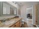Well-lit bathroom with granite countertops, a large mirror, and a view into the adjacent office space at 5746 Aspen Creek Dr, Broomfield, CO 80020