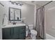 Bathroom with a modern vanity, a shower-tub combo with a gray patterned curtain, and neutral walls at 5746 Aspen Creek Dr, Broomfield, CO 80020