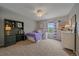 Bright bedroom featuring a work station, large window with purple curtains, and a cozy bed at 5746 Aspen Creek Dr, Broomfield, CO 80020