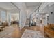 Elegant foyer with hardwood floors, staircase, and open living spaces at 5746 Aspen Creek Dr, Broomfield, CO 80020