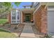 Inviting brick home entrance with a covered porch and decorative accents at 5746 Aspen Creek Dr, Broomfield, CO 80020