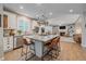 Spacious kitchen with granite countertops, stainless steel appliances, large kitchen island, and breakfast bar seating at 5746 Aspen Creek Dr, Broomfield, CO 80020