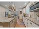 Granite countertops, stainless steel appliances, kitchen island with gas cooktop and bar seating, and ample storage space at 5746 Aspen Creek Dr, Broomfield, CO 80020