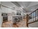 Basement kitchenette with white cabinets, granite countertops, a beverage fridge, and barstool seating at 5746 Aspen Creek Dr, Broomfield, CO 80020