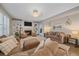 Comfortable living room with a fireplace, built-in shelving, plush seating, and natural light at 5746 Aspen Creek Dr, Broomfield, CO 80020