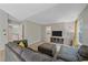 Comfortable living room with gray sectional sofa and view into the hallway at 5746 Aspen Creek Dr, Broomfield, CO 80020
