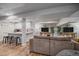 Basement living room with a large sectional sofa and a kitchenette area with barstool seating at 5746 Aspen Creek Dr, Broomfield, CO 80020
