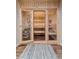 A beautifully designed sauna with glass doors, wood bench seating, and custom lighting at 5746 Aspen Creek Dr, Broomfield, CO 80020