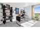 Sunlit home office with modern desk, shelving, decor, and comfortable chair offering inspiring workspace at 1348 S Boston Ct # A, Denver, CO 80247