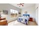 Inviting bedroom featuring a large window with views, complemented by soft lighting at 16500 Crosby Dr, Broomfield, CO 80023