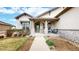 Inviting front porch with stone pillars, a seating area, and a beautifully landscaped walkway at 16500 Crosby Dr, Broomfield, CO 80023