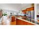 Modern kitchen featuring stainless steel appliances, granite countertops, and a view of the dining and living areas at 16500 Crosby Dr, Broomfield, CO 80023