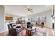 Bright living room with a colorful rug, wood floors, and a cozy seating area with large windows at 16500 Crosby Dr, Broomfield, CO 80023