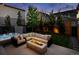 Cozy backyard featuring a hot tub, comfortable outdoor seating, and a modern fire pit at 6123 Chester Way, Denver, CO 80238