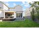 Spacious backyard with a covered patio, a hot tub, and a lush green lawn at 6123 Chester Way, Denver, CO 80238