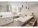 Wet bar with white cabinets, pendant lighting, and a quartz countertop with seating at 6123 Chester Way, Denver, CO 80238