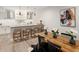 Finished basement featuring a wet bar with modern lighting and seating at 6123 Chester Way, Denver, CO 80238