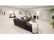 Finished basement with a large sectional sofa, plush carpet and workout room access at 6123 Chester Way, Denver, CO 80238