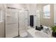 Modern bathroom featuring a glass-enclosed shower, white subway tile and vanity at 6123 Chester Way, Denver, CO 80238